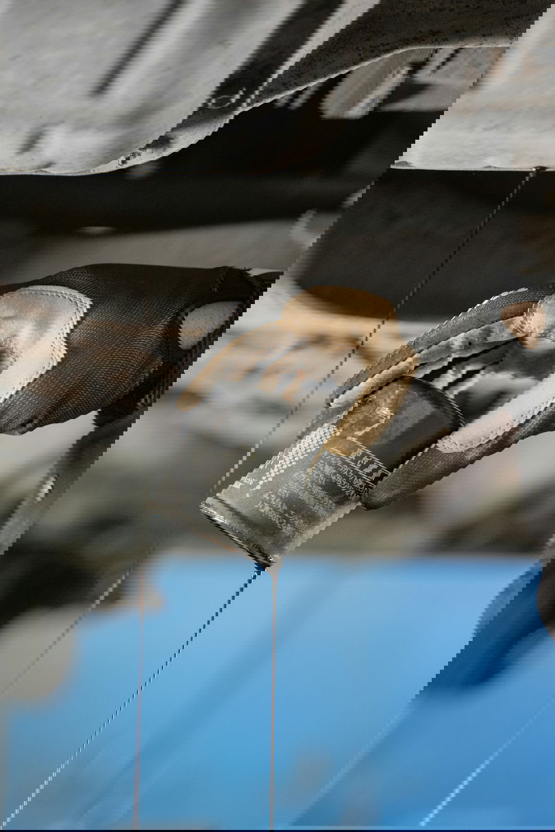 a mechanic is pouring oil on a car